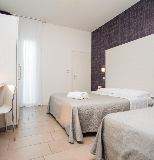 Modern, bright, and cozy room with comfortable beds.