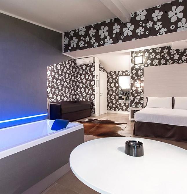 Elegant room with bathtub, floral decor, relaxing ambiance.