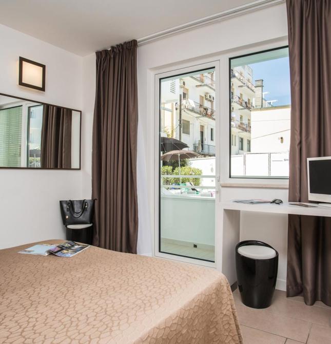 Bright room with balcony, brown curtains, and modern furnishings.